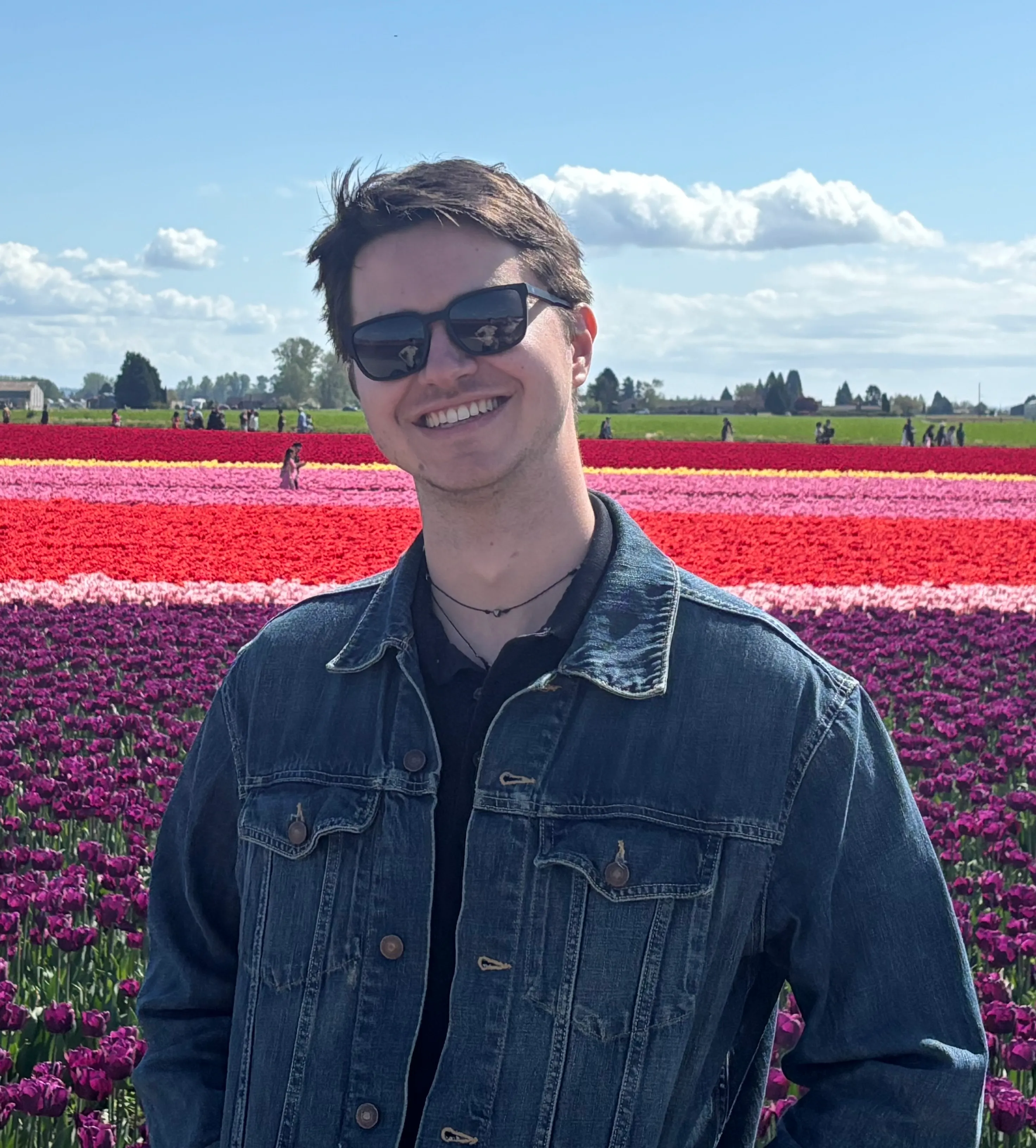 Man in front of a field of flowers